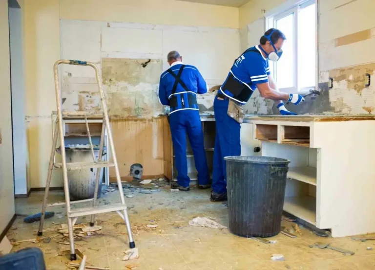 Workers performing home remodeling and kitchen renovation work.