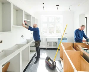 Home remodeling solutions with workers installing cabinets in modern kitchen renovation.